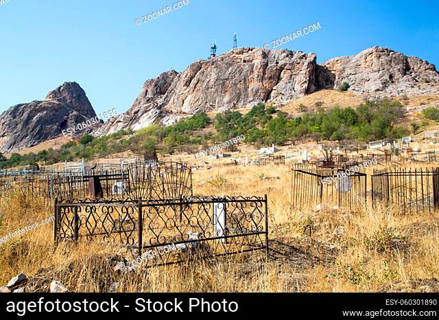 Osh, Kyrgyzstan - October 05, 2014: A traditional muslim cemetery at the foot of Sulaiman Too Mountain