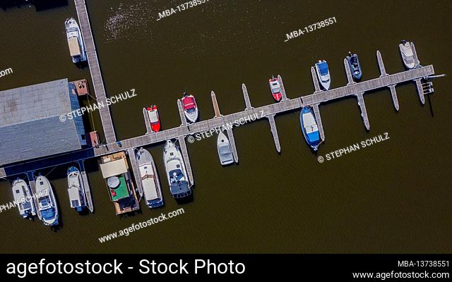 Pleasure boats lie on a wooden pier