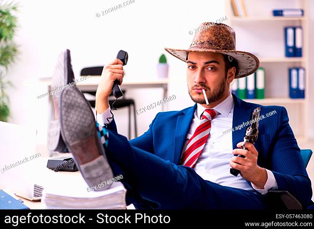 Businessman cowboy working in the office