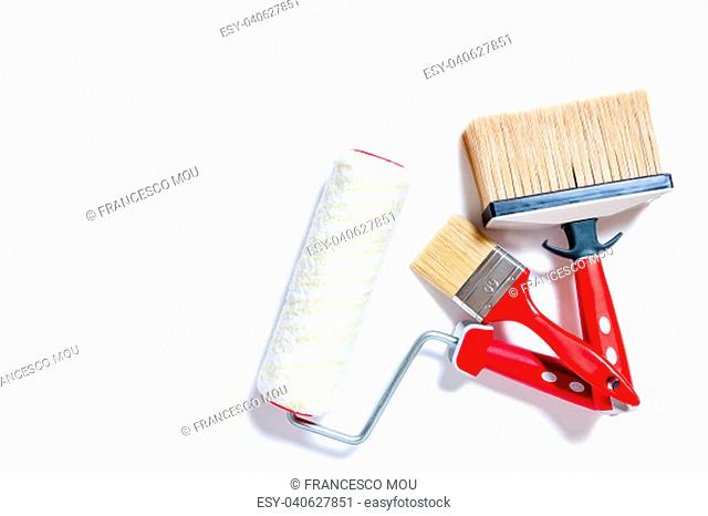 Top view of brushes and roller for professional house painter, photographed on white background