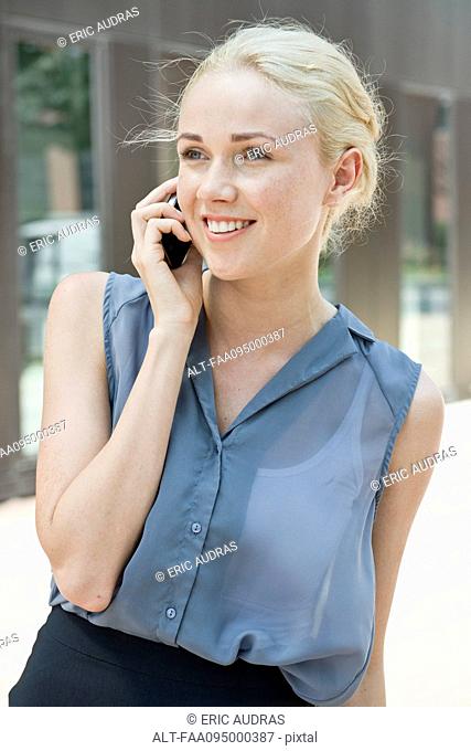 Young woman making phone call using smartphone