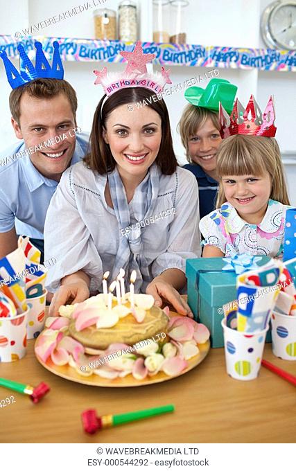 Cheerful family celebrating mother's birthday in the kitchen