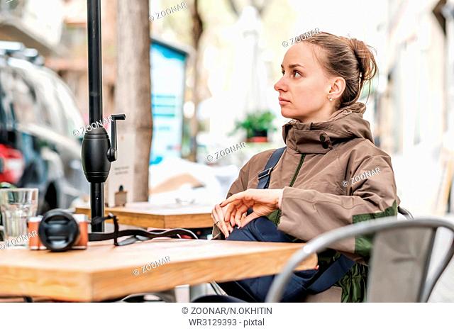 Woman with camera in outdoor cafe. Barcelona, Catalonia