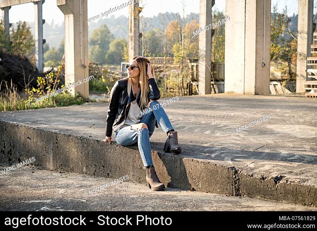 Young woman in casual clothes in an industrial area