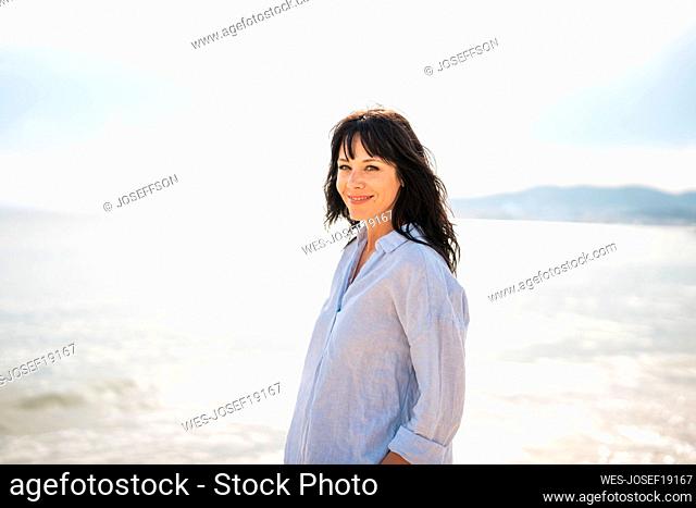 Smiling woman spending vacation at beach
