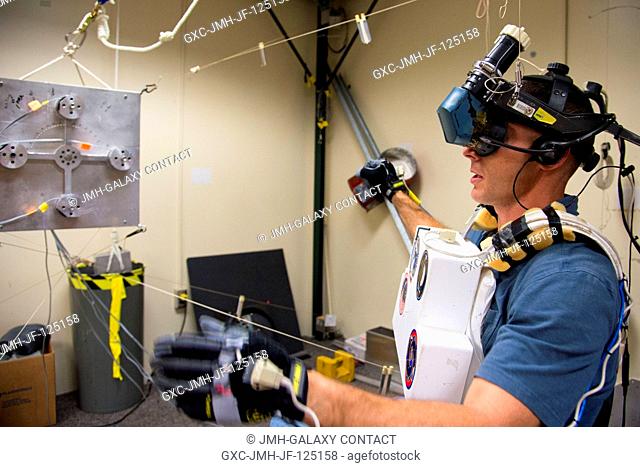 NASA astronaut Michael Hopkins, Expedition 3738 flight engineer, uses virtual reality hardware in the Space Vehicle Mockup Facility at NASA's Johnson Space...