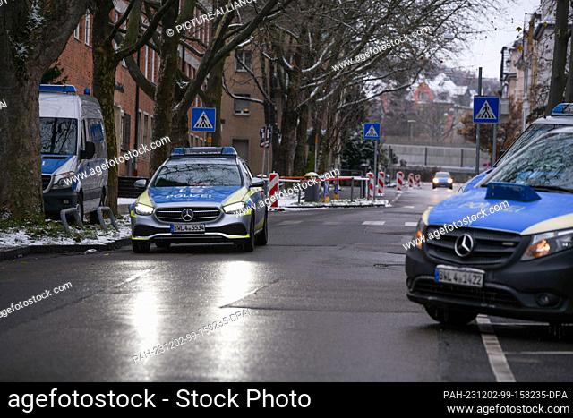 02 December 2023, Baden-Württemberg, Stuttgart: Police officers stand in front of an event site. The police are there to prevent another clash between opposing...