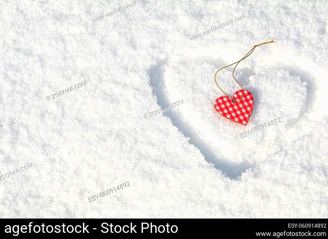 Beautiful valentine holiday background with checkered motley heart on white snow surface