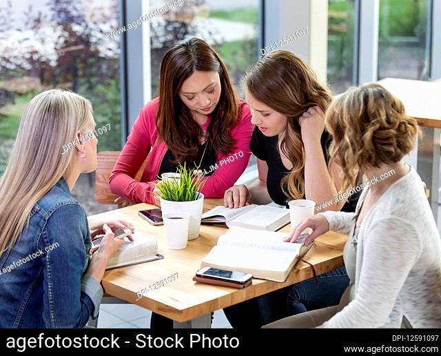 A group of women gathered together for a Bible study in a coffee shop at a church; Edmonton, Alberta, Canada