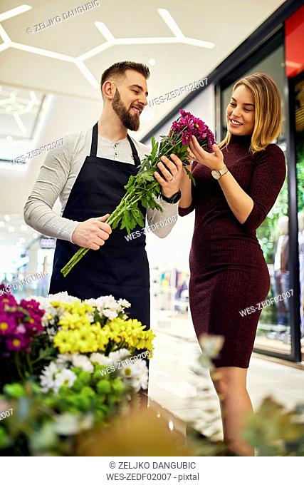 Florist advising customer in flower shop