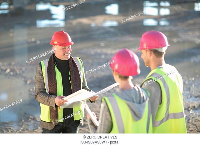 Architect meeting with builders on construction site