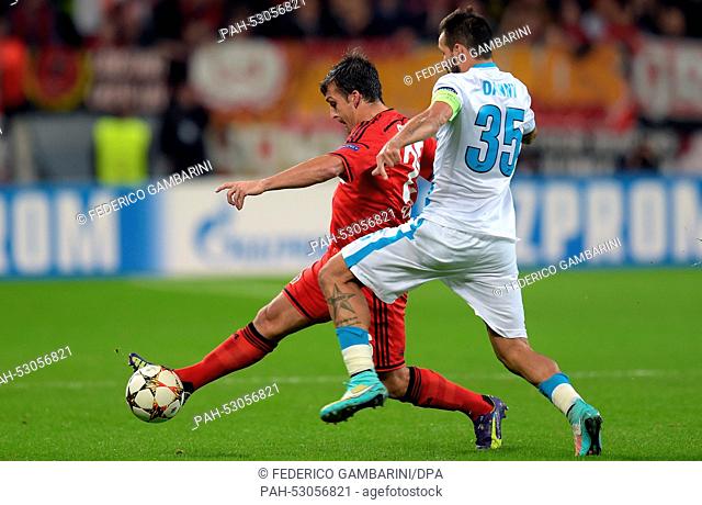 Leverkusen's Giulio Donati (L) and St. Petersburg's Danny (R) vie for the ball during the Champions League group C match between Bayer Leverkusen and Zenit St