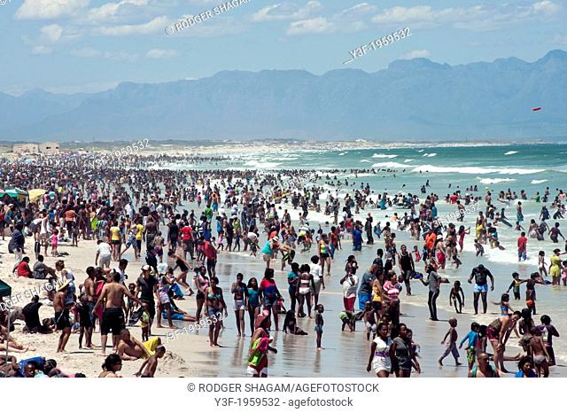 Crowds op people flock to the beach on a warm summer's day. New Year's Day. Cape Town, South Africa