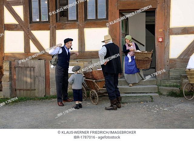 Family wearing clothing from the 1930's on their way to the plum harvest, Europa Park near Neu-Anspach, Hochtaunuskreis district, Hesse, Germany, Europe