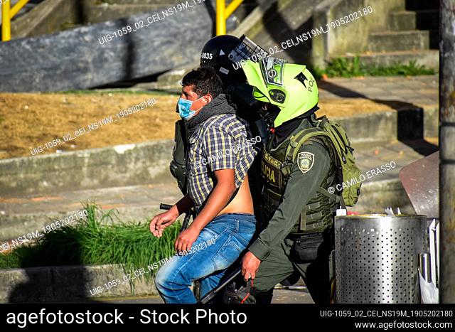 Police members capture demostrator who was taking part in national strike riots in Pasto, Narino on May 19, 2021 during an antigovernment protest against police...