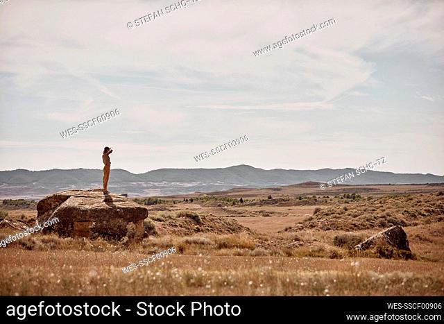 Woman standing on rock in steppe