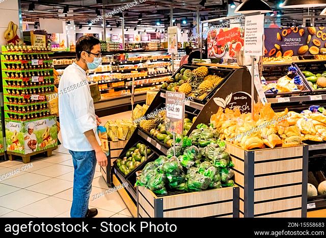 Cape Town, South Africa - March 23, 2020: Person wearing a protective mask while shopping at Pick 'n Pay grocery store during virus outbreak