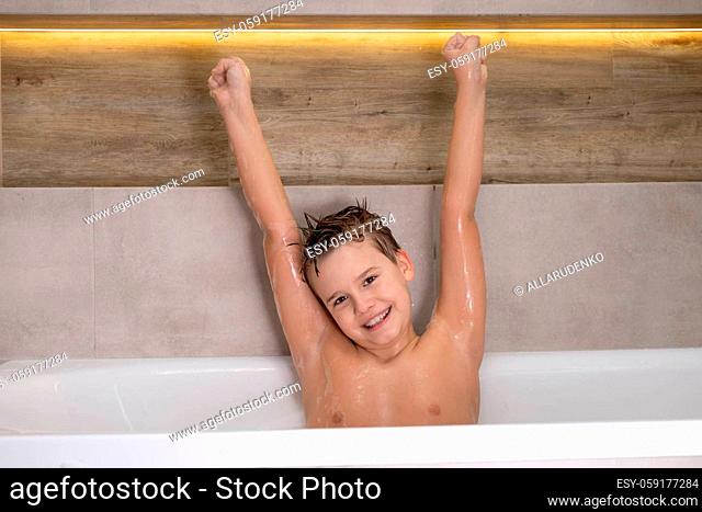 Portrait of happy wet nude boy in bathroom Smiling Child bathes at home