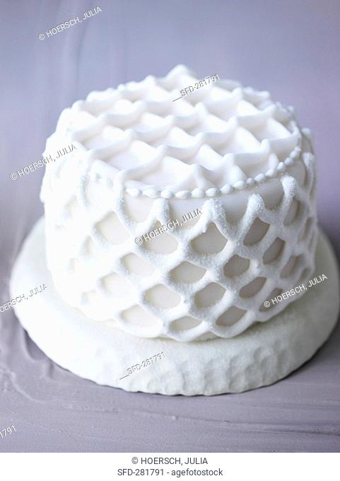 Small white cake with lattice decoration