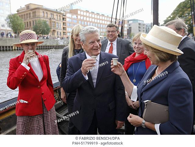 Denmark's Queen Margrethe II (L), German President Joachim Gauck and his partner Daniela Schadt (R) toast with traditional Danish Mead honey wine as they visit...