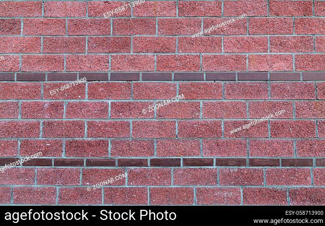 Brick red background with borders of narrow rectangular stone border symmetrical texture
