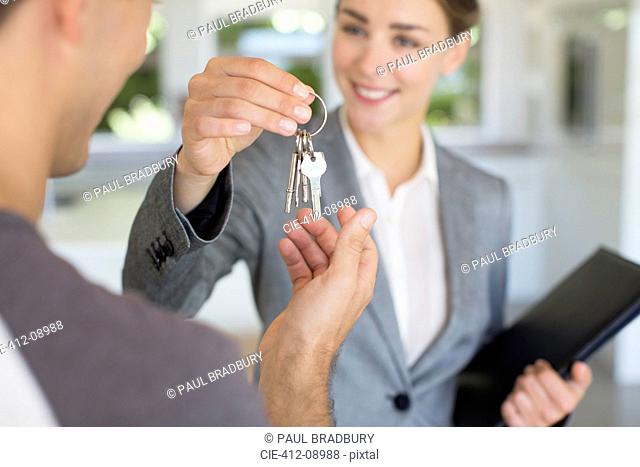 Realtor giving man house keys