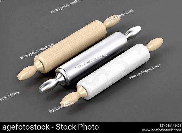 Three rolling pins from different materials on grey background
