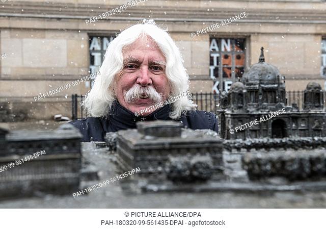 20 March 2018, Germany, Berlin: Sculptor Egbert Broerken kneeling behind the cathedral after the unveiling of his expanded tactile model of the Museumsinsel...