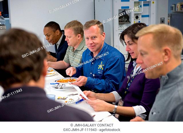 STS-133 crew members participate in a food tasting session in the Habitability and Environmental Factors Office at NASA's Johnson Space Center