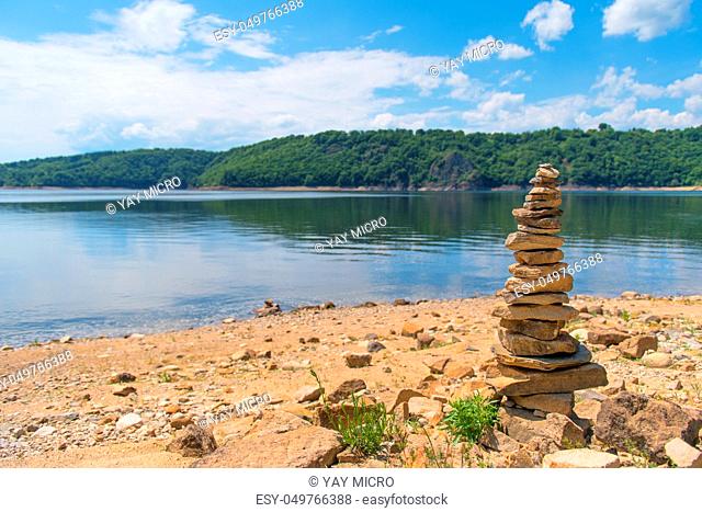 Stacked stones near artificial lake in French Auvergne