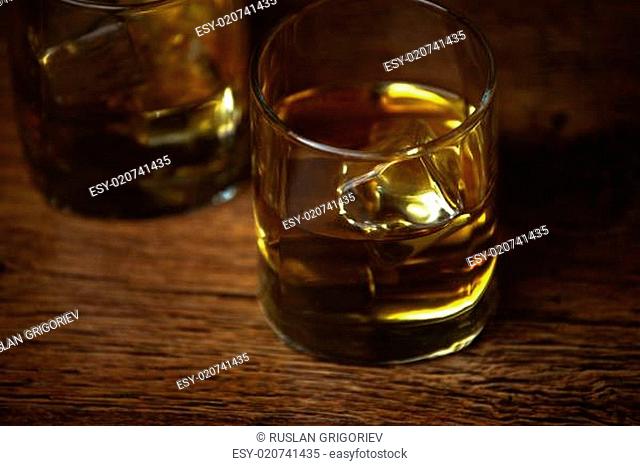 shot of whiskey on old wooden surface