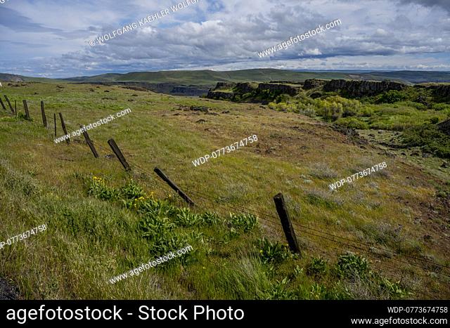 View from the Dalles Mountain Road near Lyle, Washington, USA, towards the Columbia River and Oregon, with a fence in the foreground