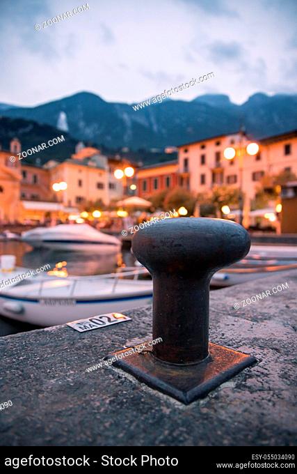 Italian harbour in the evening, small cute village and lighrs in the blurry background