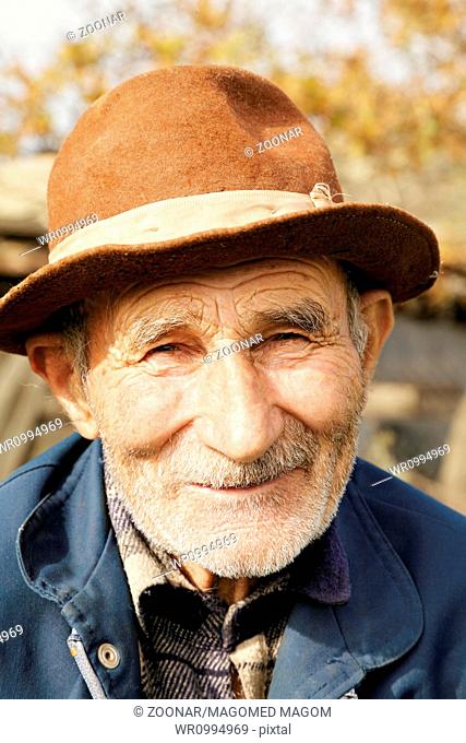 Positive senior man in hat