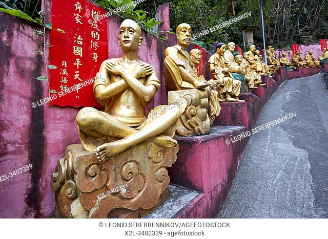 Statues of arhats (Buddhist equivalent of saints) on the way up to Ten Thousand Buddhas Monastery (Man Fat Sze). Sha Tin, New Territories, Hong Kong