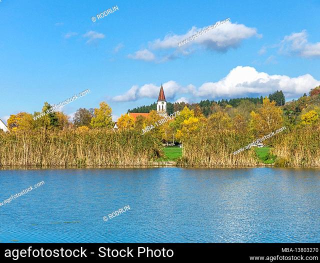 Germany, Baden-Wuerttemberg, Illmensee, view over the Illmensee to the cath. Parish Church of the Assumption. The Illmensee is located in the FFH area 8122-342...