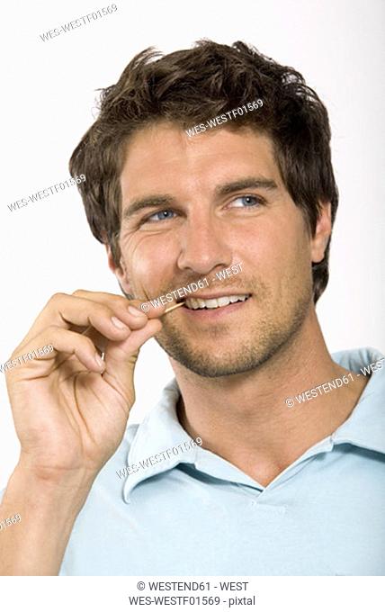 Young man with toothpick, portrait