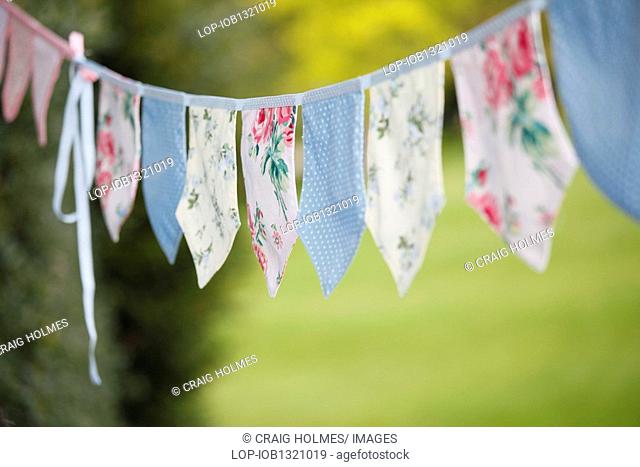 England, West Midlands, Edgbaston, Fabric bunting hanging in a garden