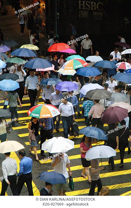 Pedestrians crossing a road in a rainy day, Central, Hong Kong