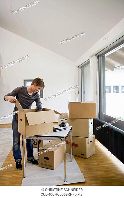 Man unpacking cardboard boxes