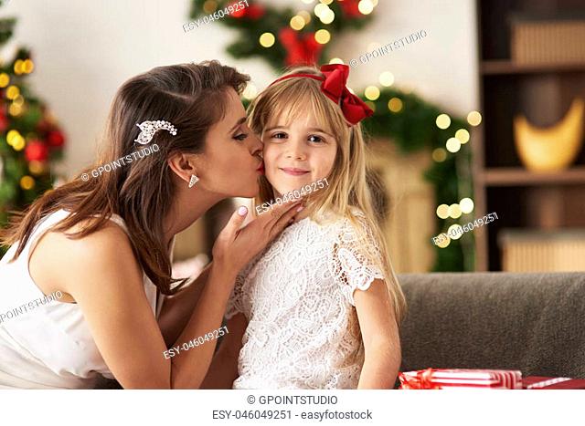 Mother kissing daughter on cheek
