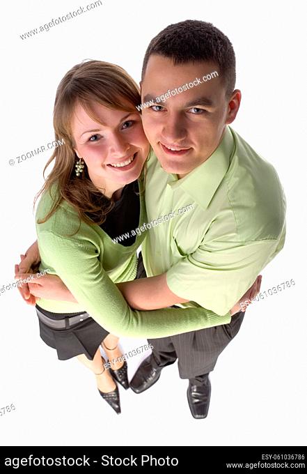Headshot of young happy couple, standing and looking at the camera. Isolated on white in studio