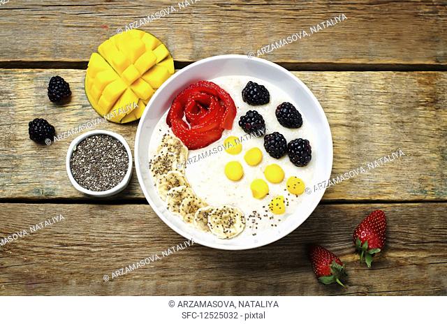 Breakfast oatmeal porridge with strawberry, mango, blackberry, banana and Chia seeds
