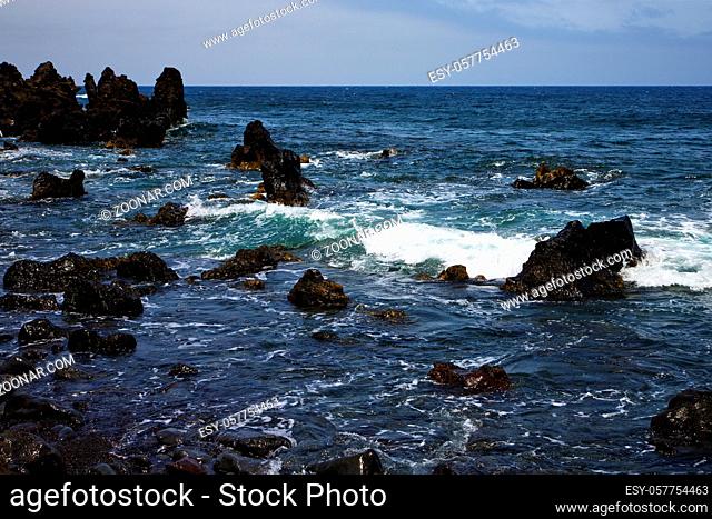 rock spain sky light beach water in lanzarote isle foam landscape stone cloud