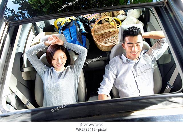 Young couple driving on trip