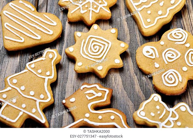 Christmas Ginger and Honey cookies on wooden background. Star, fir tree, heart, bear shape
