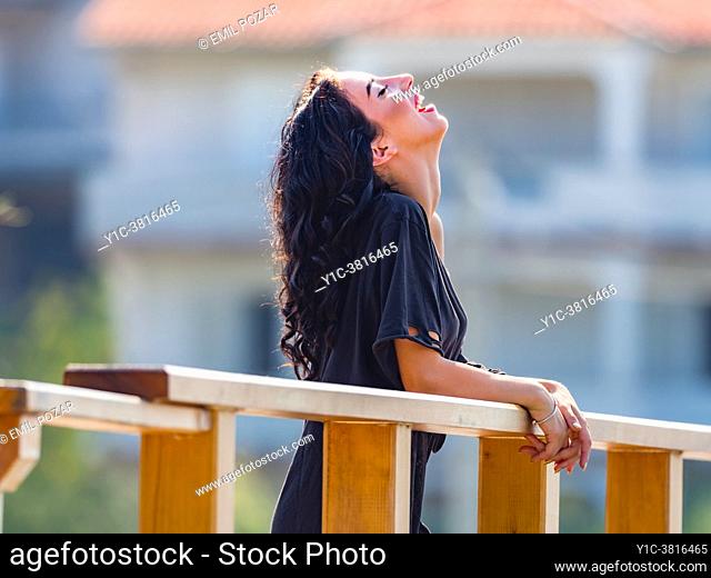 Hilarious laugh teen girl on wooden foot-bridge