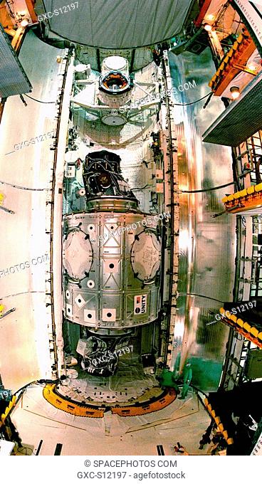 11/16/1998 --- This fish-eye view of the Unity connecting module reveals its immense size relative to the workers below right