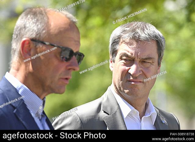 Markus SOEDER (Prime Minister of Bavaria and CSU Chairman), looks at Friedrich MERZ. Prime Minister Dr. Markus Soeder visits the Isar 2 nuclear power plant on...