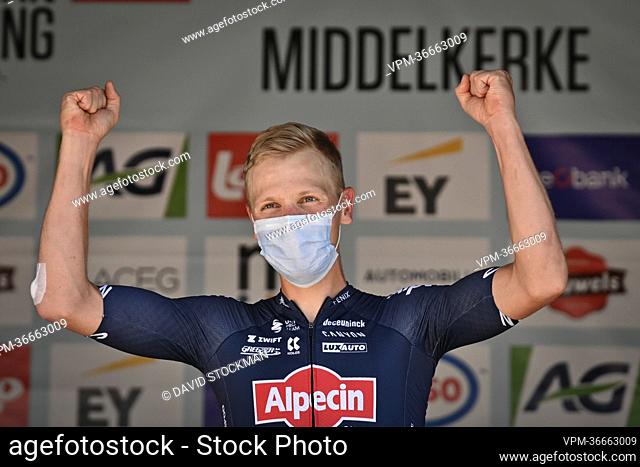 Belgian Tim Merlier of Alpecin-Fenix celebrates on the podium after winning the men's elite race at the Belgian cycling championships